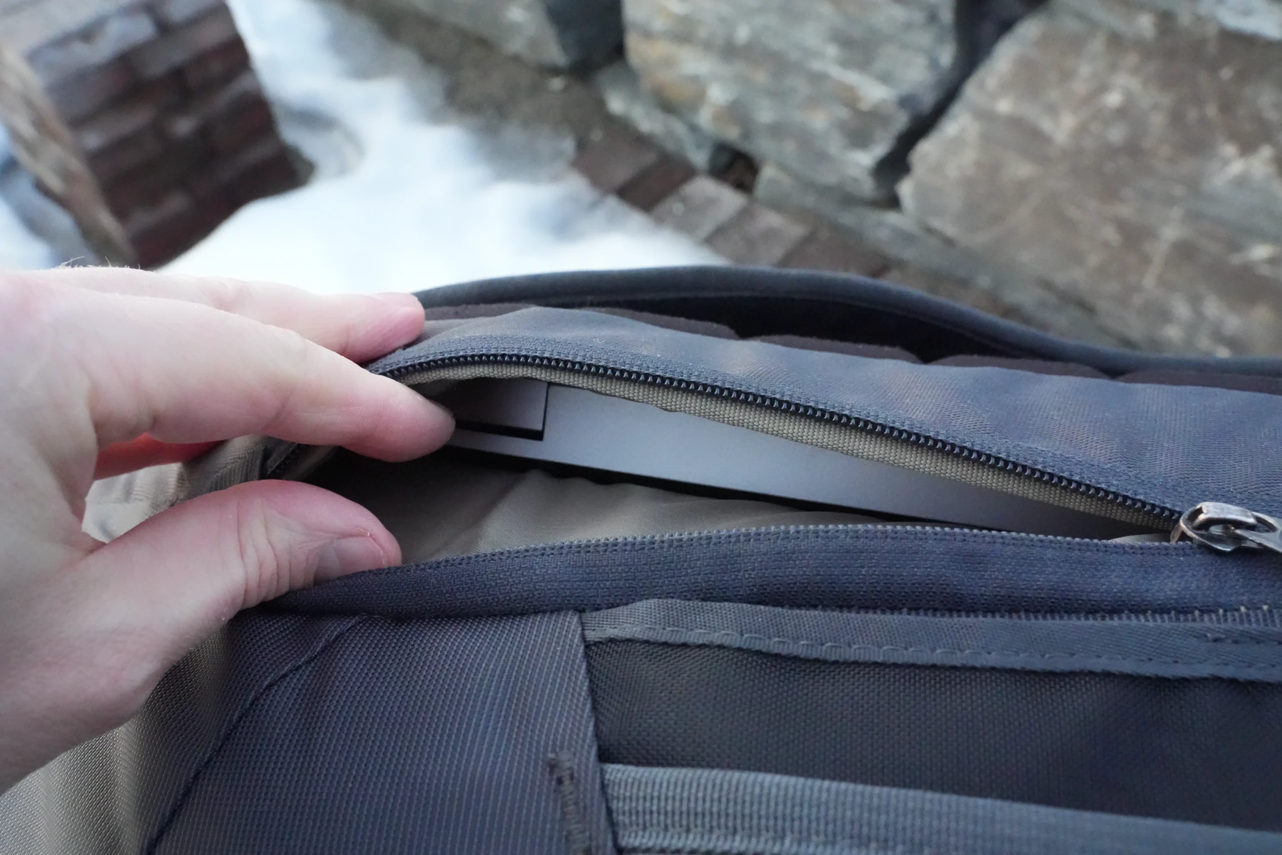 Thule Landmark 40 laptop sleeve access showing tight fit when bag is packed