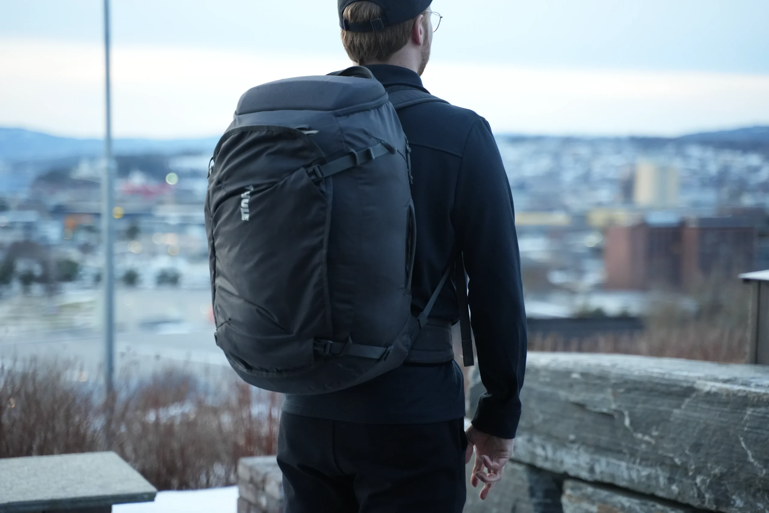 Thule Landmark 40 worn from rear at dusk showing bag shape and color in evening light