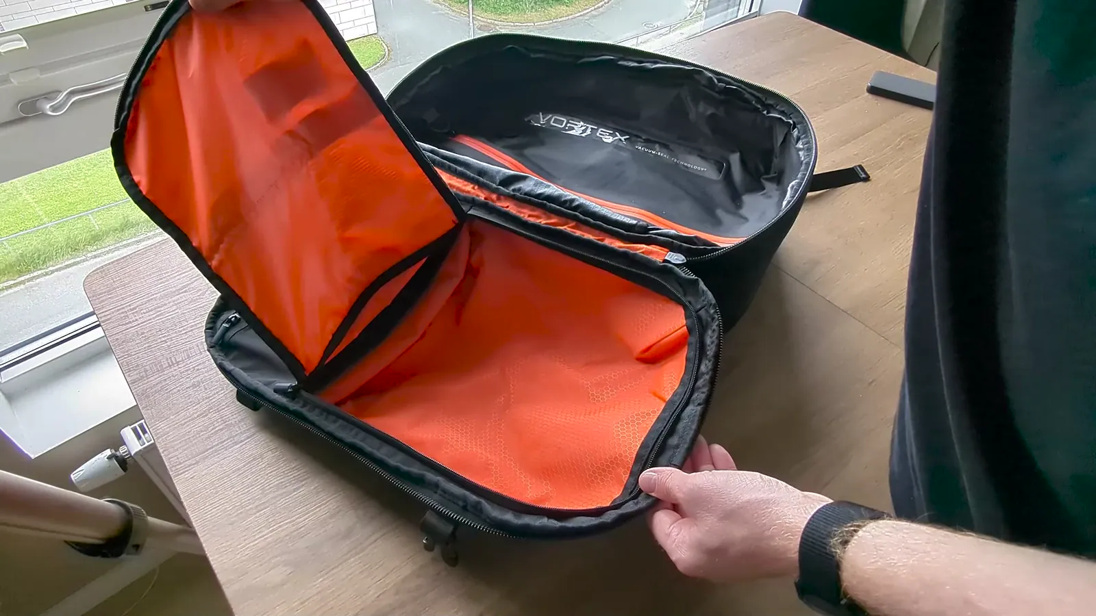 Zephyr Pro Lite open main compartment showing the orange vacuum chamber and stretch pockets
