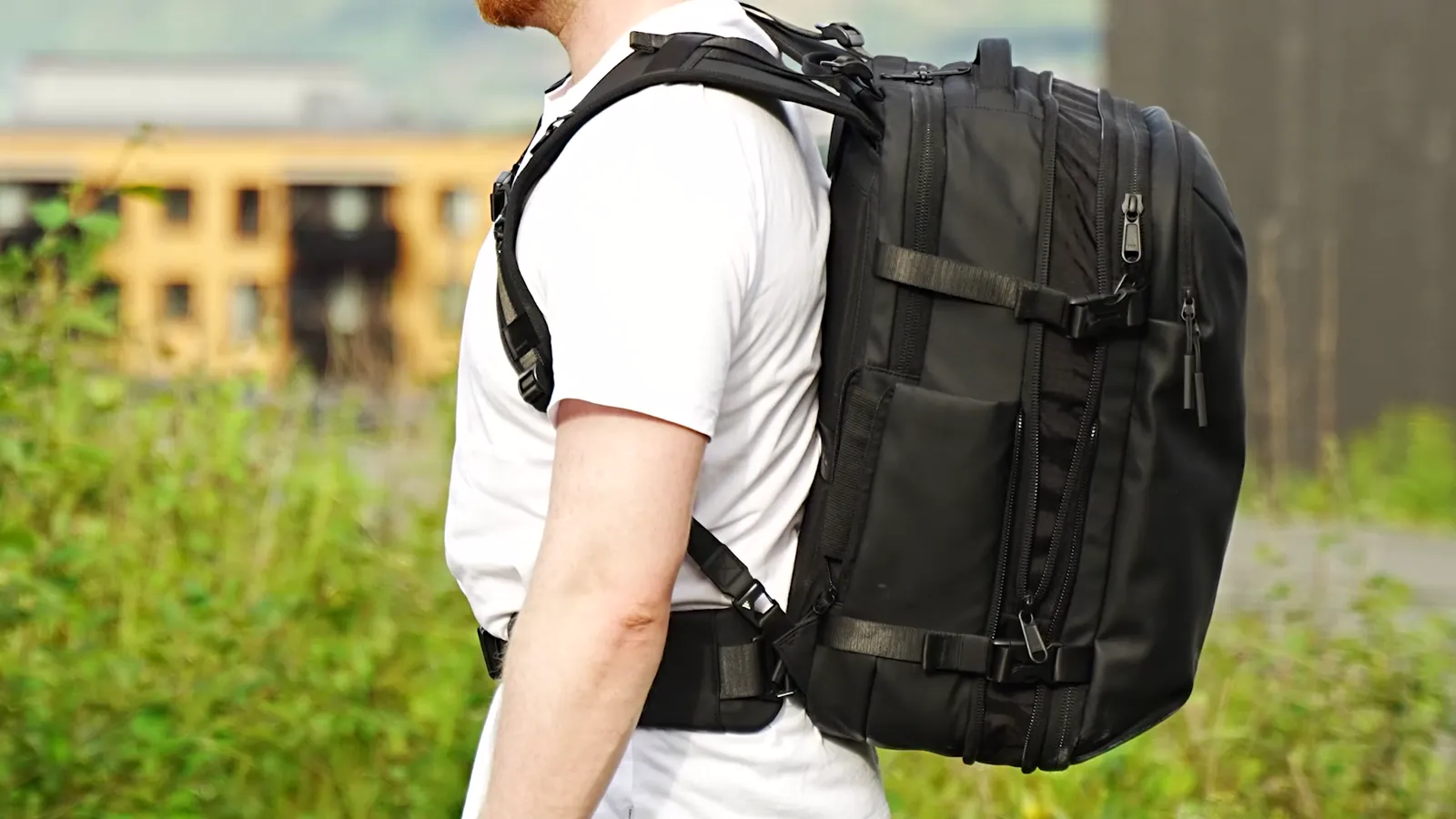 Zephyr Pro Lite travel backpack worn, side profile outdoors