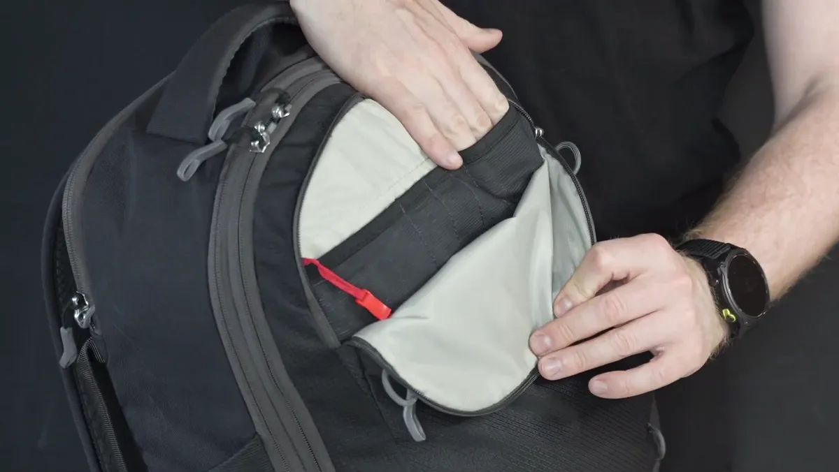 The top admin pocket of the Osprey Daylite 26+6 open, showing the mesh organisers and key clip