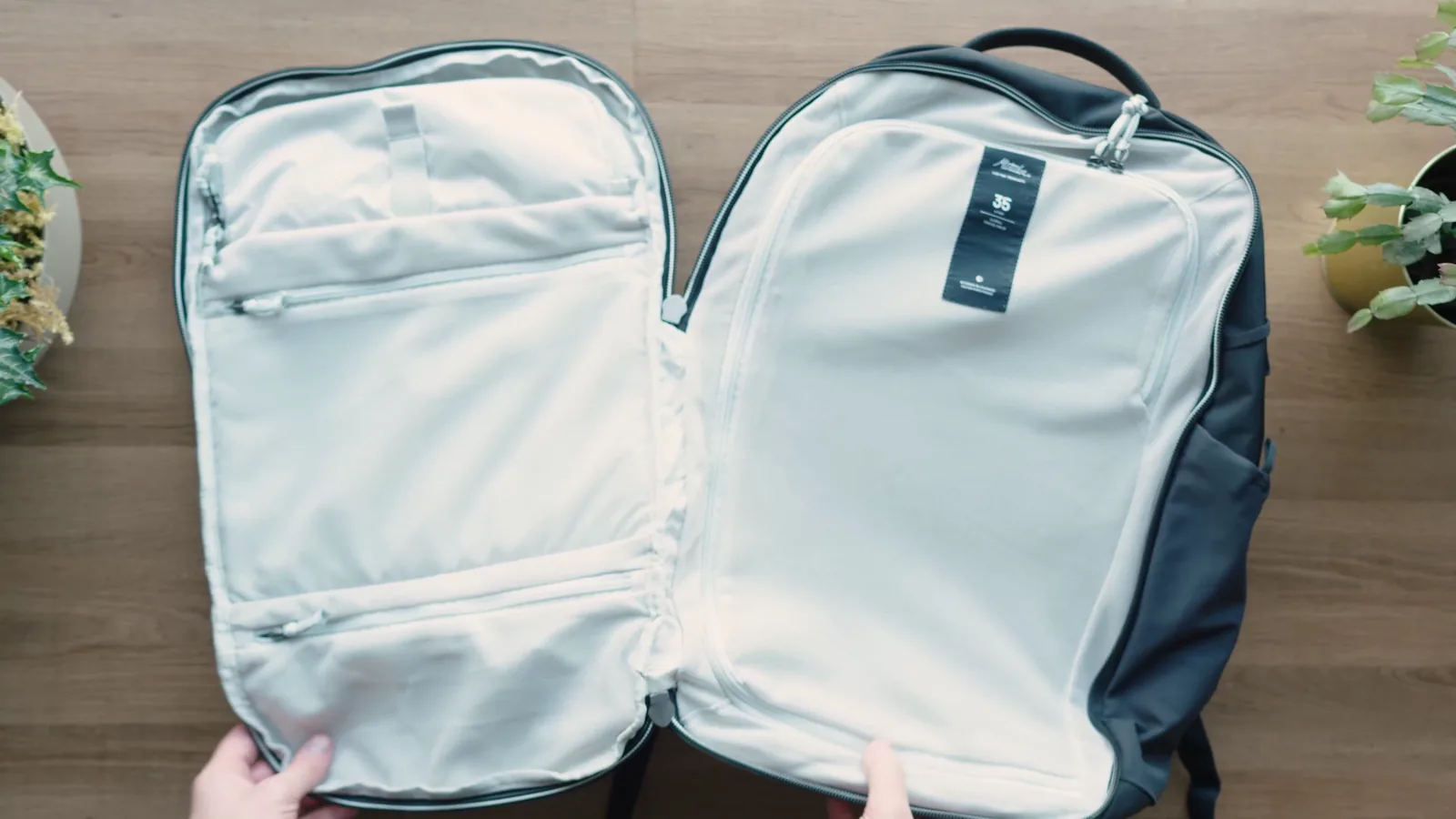 Matador Global Travel Pack 35 opened flat like a clamshell, with mesh covering the main compartment