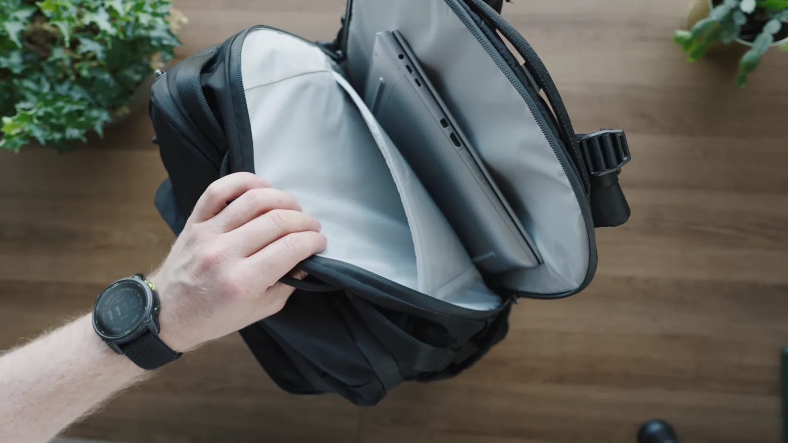 A 16 inch laptop in the laptop compartment of the Matador Global Travel Pack 35